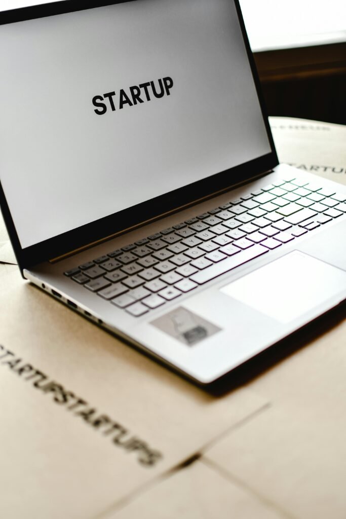 Modern laptop with startup text on screen, ideal for business themes.